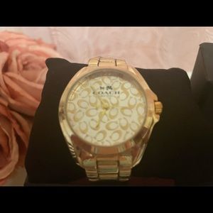 Gold coach watch. New with plastic wrap .